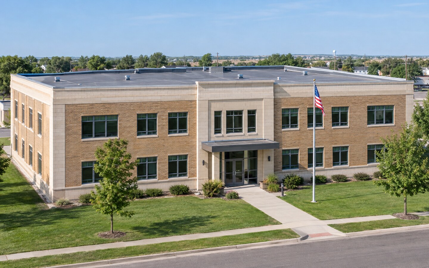 Illustrative municipal administration building with a flat commercial roof and flagpole