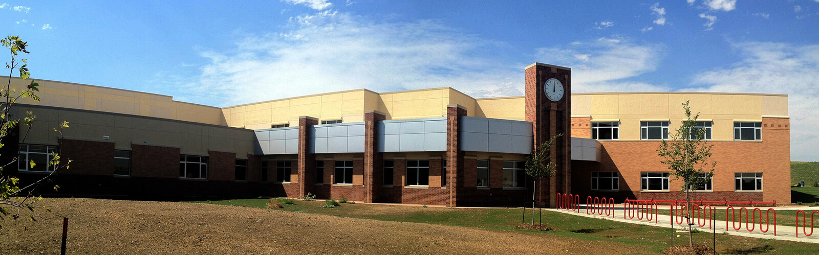 East Middle School exterior with brick walls, a clock tower, and red railings